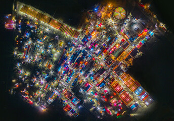 Aerial view of traditional village fair in Bangladesh. Colorful tents of temporary shops make it look like blocks of tetris game.  Portable ferris wheel