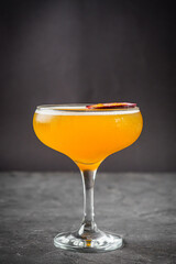 bright colored alcoholic cocktail on a black stone background