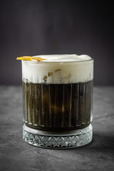 bright colored alcoholic cocktail on a black stone background