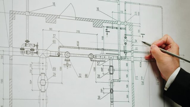 Architect designer working with plan blueprint close-up. Professional engineer showing on scheme, interior creator making architectural house project, drafting building.