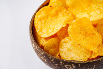 golden crispy potato chips on a white background
