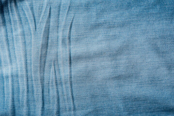 Old Blue jeans fabric denim texture background for design. Canvas denim. Close up view.