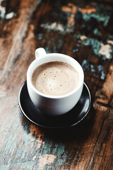 Cup of coffee on wooden background. Close up.