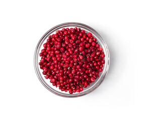 pink peppercorns in a glass bowl isolated on white background (top view)