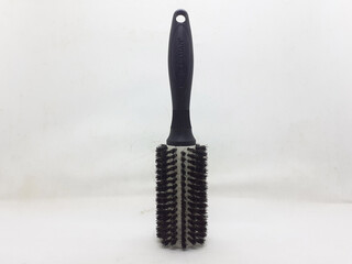 Used Black Brown Hair Comb with some Hairs in White Isolated background