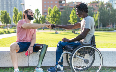 Two disabled friends give fist bump as a sign of friendship  and determination - Powered by Adobe