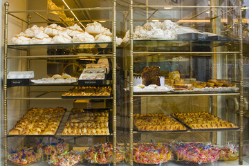 Appetizing portuguese pastries at pastry shop display in Coimbra