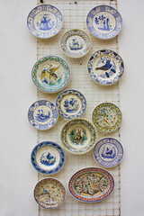 Traditional ceramic plates with azulezh at souvenir store in Coimbra, Portugal