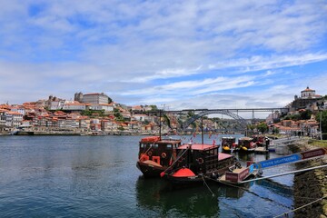 Obraz premium Historical Port Barges ‘Rabelo’ boats used to transport Port wine from the vineyards to Vila Nova de Gaia on the Douro river in Porto, Portugal
