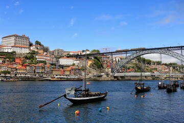 Fototapeta na wymiar Historical Port Barges ‘Rabelo’ boats used to transport Port wine from the vineyards to Vila Nova de Gaia on the Douro river in Porto, Portugal