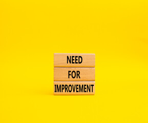 Need for Improvement symbol. Wooden blocks with words Need for Improvement. Beautiful yellow background. Business and Need for Improvement concept. Copy space.