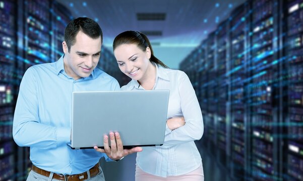 CEO Talking to Young Confident Manager while Using Computer in Modern Office. Colleagues Discuss Commercial, Marketing Projects. Specialists Work in Diverse Team.