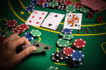 Fototapeta premium Happy poker player winning and holding cards.