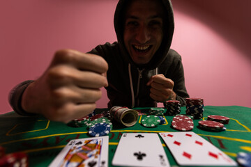 man at green playing table with gambling chips and cards playing poker and blackjack in casino