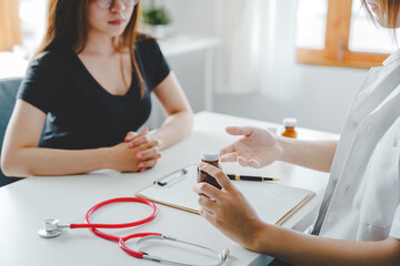 portrait of a female doctor She is recommending medications and treatment methods at the clinic.