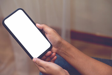 woman's hand holding a cell phone with a white screen