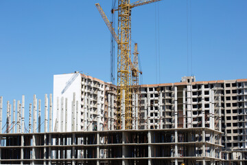 Construction site background. Cranes and new high-rise buildings. Reference information about the industry.