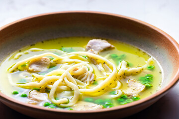 chicken broth with green peas and noodles