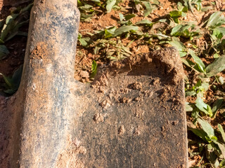 Detail of a dirty shovel on the grass. Gardening, landscaping.