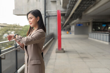 Businesswoman is using Smart watch in Modern city , business technology , city lifestyle concept