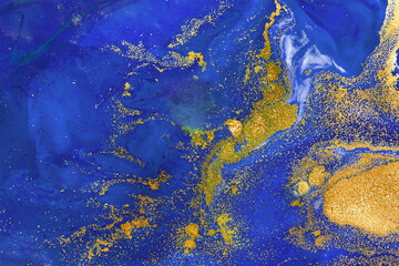 Alcohol ink blue transparent background. Blue, ocean and gold ink texture. Modern luxury paint natural colors with glitter. Template for banner, poster design. High Resolution watercolor texture