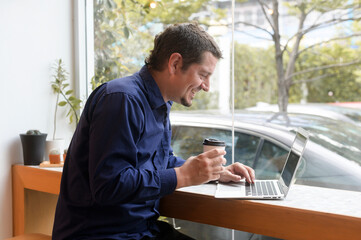 Fototapeta premium Portrait of business caucasian man in coffee shop
