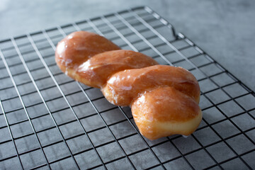 A view of a glazed twist donut.
