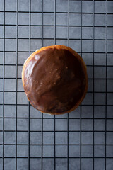 A top down view of a chocolate cream filled donut.