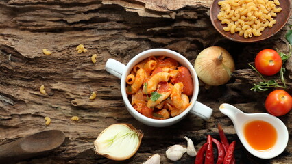 Stir Fried Macaroni with Vegetables and Seasonings in white plate on wooden background
