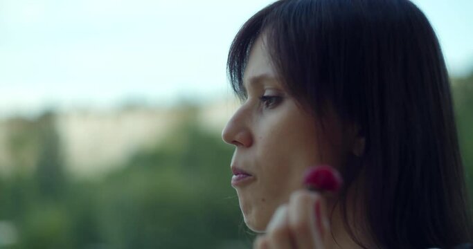 Godless hedonism concept with woman enjoy eat of strawberry on terrace at erly morning