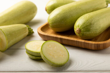 Squash vegetable marrow zucchini on white texture background.Vegetarian organic vegetables.Healthy food.Copy space.Place for text