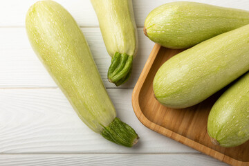 Squash vegetable marrow zucchini on white texture background.Vegetarian organic vegetables.Healthy food.Copy space.Place for text