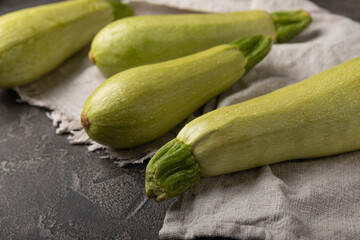 Squash vegetable marrow zucchini on black texture background.Vegetarian organic vegetables.Healthy food.Copy space.Place for text