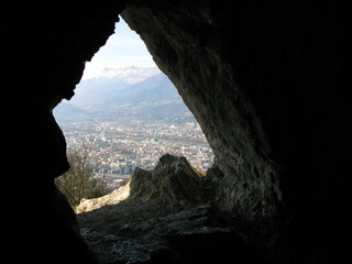 Grenoble, Bastille fortress. View of the city from Mandrin Cave. The view from the dark cave at a...