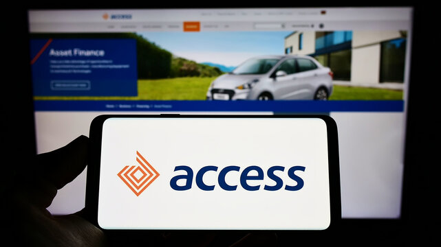 Stuttgart, Germany - 06-10-2022: Person holding mobile phone with logo of Kenyan financial company Access Bank PLC on screen in front of business web page. Focus on phone display.
