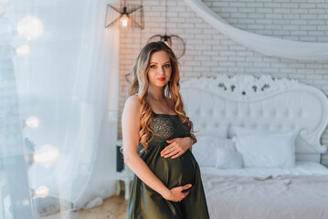 young pregnant woman holding her hands on her tummy