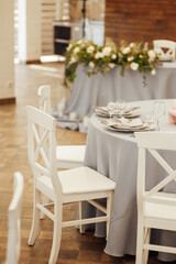 A very beautiful festive table with candles, plates and glasses. Cool room decor