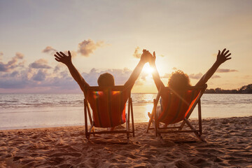 Fototapeta beach holidays, happy retired couple enjoying sunset near the sea, holding hands obraz
