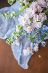 Close-up of Pink Stock and Blue Bellflowers on a Wood Table