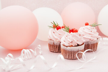 Three strawberry pink cupcakes on glitter background with air balloons, beautiful card