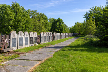 Fototapeta na wymiar New Jewish cemetery, row of many Jewish graves with matzevas and epitaphs, Lublin, Poland
