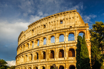 The Colosseum amphitheatre in the centre of the city of Rome at sunset, Italy, Europe.