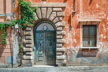 Fototapeta na wymiar Historic house in a street of The Trastevere city district in Rome