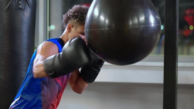 healthy lifestyle and physical activity of youth, black guy is boxing alone in gym