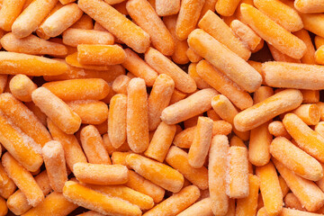 Frozen baby carrot vegetable. Mini orange carrots.