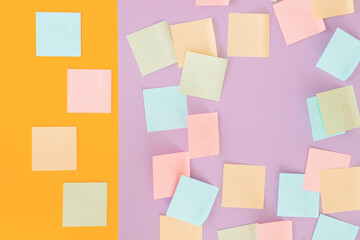 Colorful sticky notes on yellow and violet background.