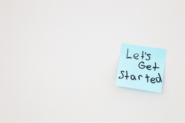 top view of blue card with let's get started lettering on white background