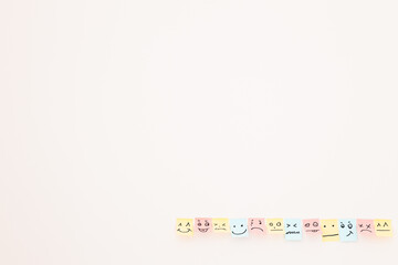 top view of paper cards with various smileys on white background