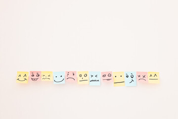 top view of paper cards with various smileys on white background