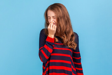 Stink, awful odor. Woman wearing sweater pinching nose, stop breathing bad odor, disgusted by smell...
